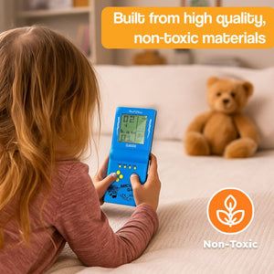 Child playing with 9999-in-1 retro game console handheld device in living room with teddy bear in background